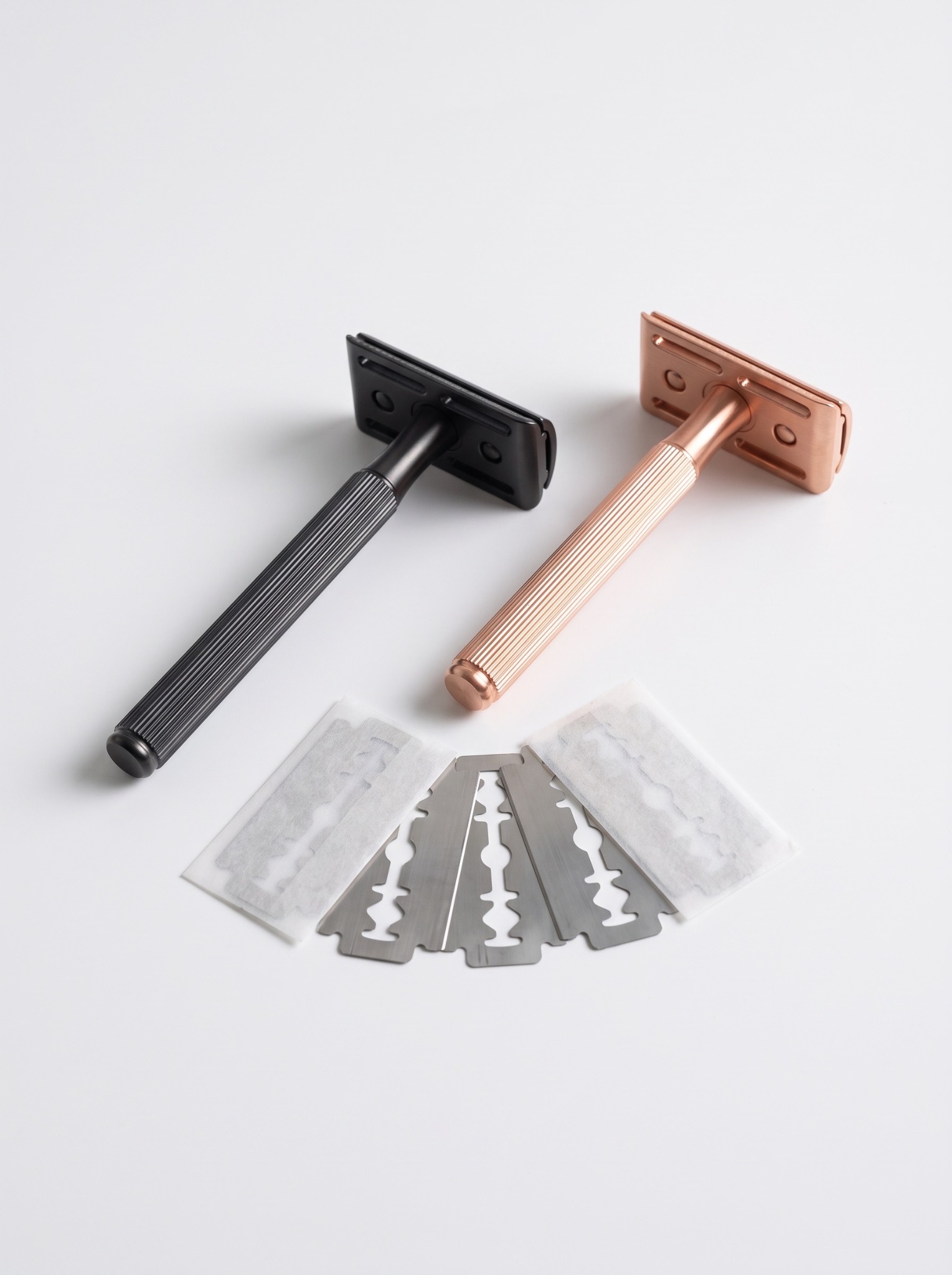 Everything Bald black and rose-gold safety razors with five included blades